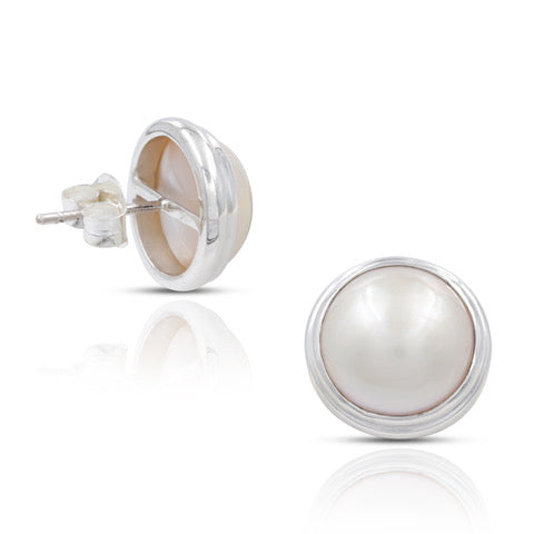A pair of Mabe pearl stud earrings with a silver finish and butterfly backings, on a white background.