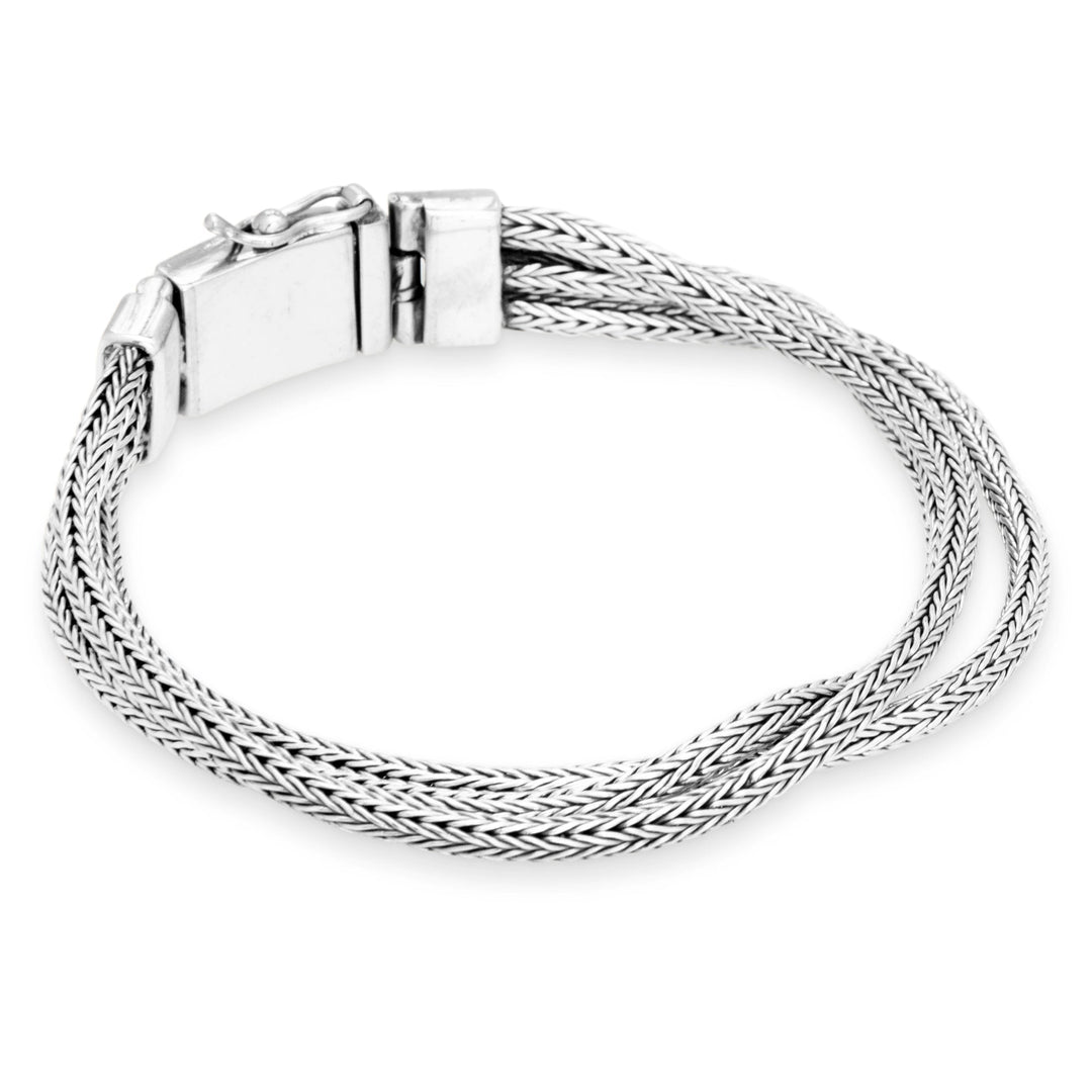 Silver braided bracelet on a white background