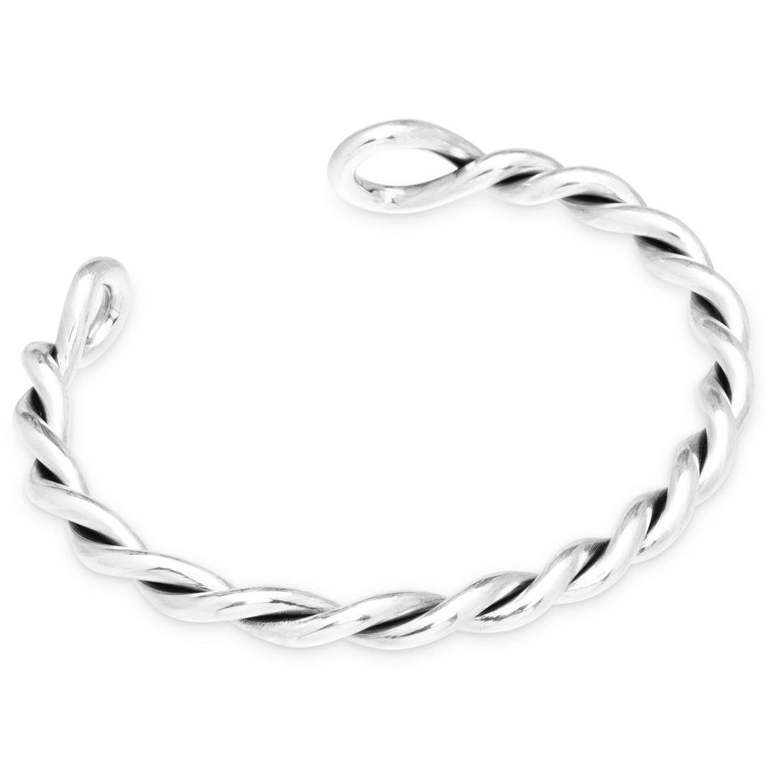 Silver twisted ring on a white background