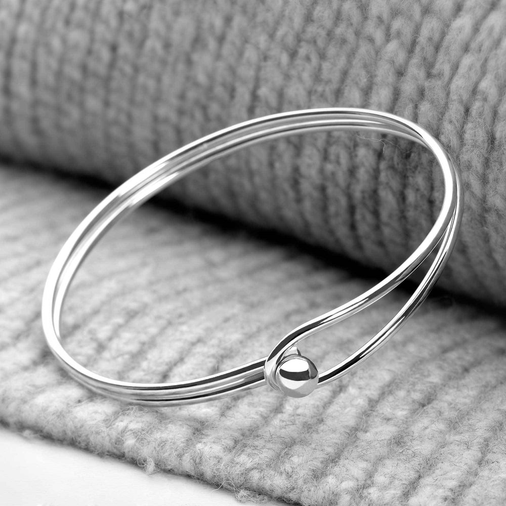 925 sterling silver fused double band loop bangle on neutral background. 