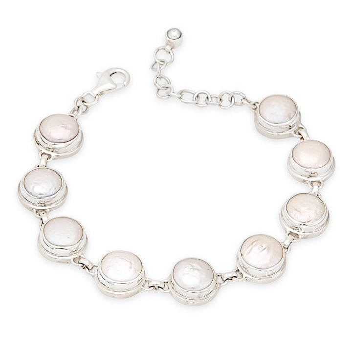 Silver bracelet with round white stones on a white background