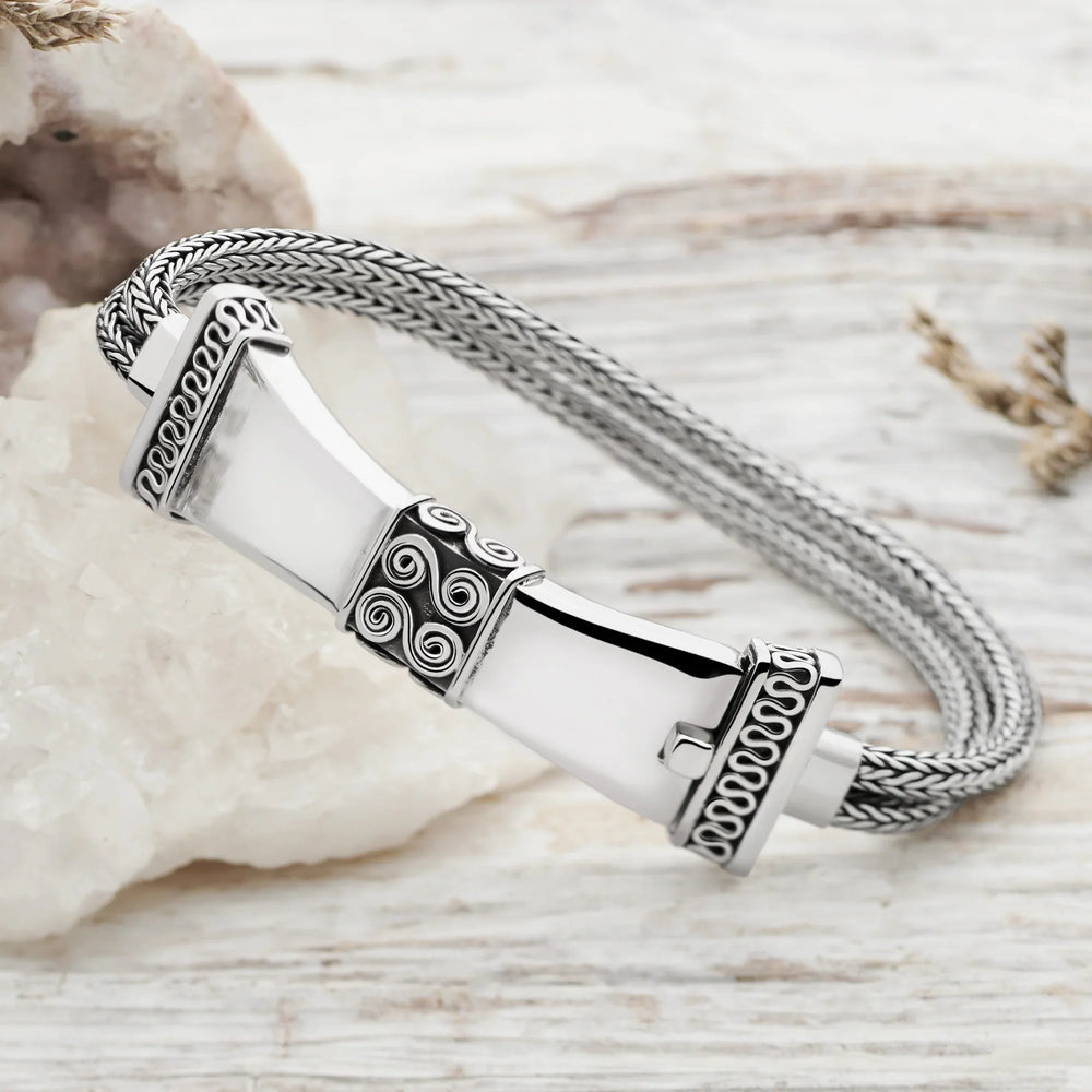 A sterling silver bracelet with a detailed Balinese wirework design and a shapely tactile clasp.