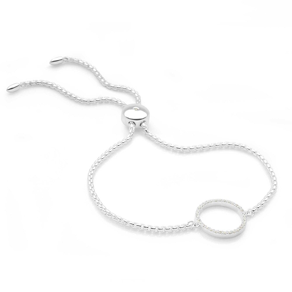 A woman wearing a silver bracelet with a sparkling halo design on white background