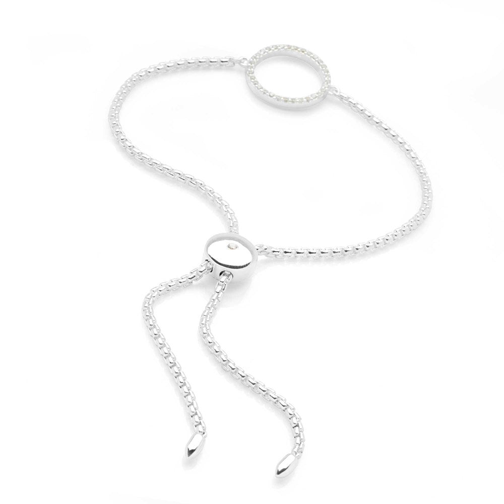 A woman wearing a silver bracelet with a sparkling halo design on white background