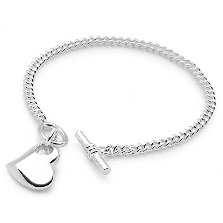 A silver bracelet with a heart-shaped charm and a classic belcher chain with a T-bar clasp.