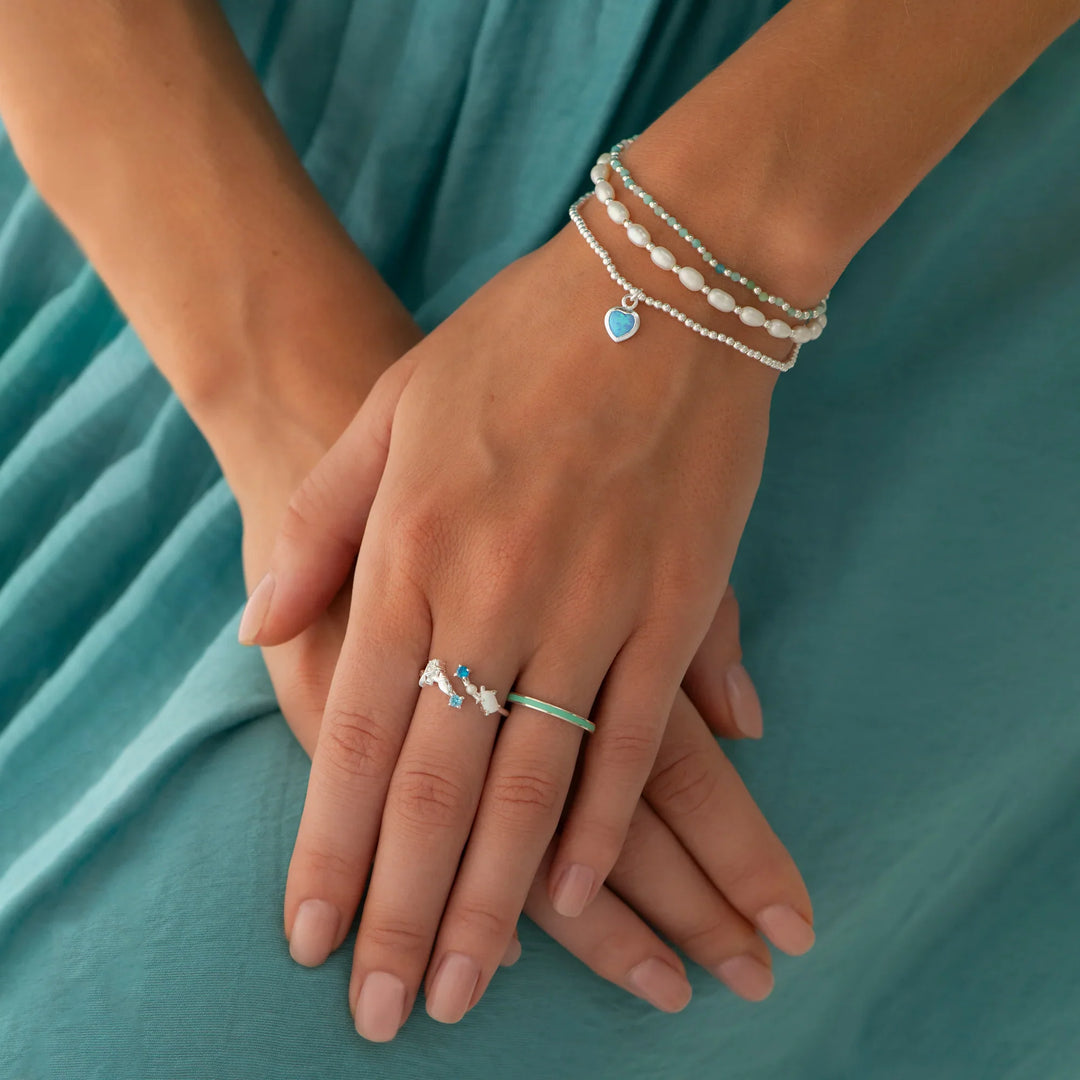 A bracelet with mini-faceted amazonite beads and silver balls on model