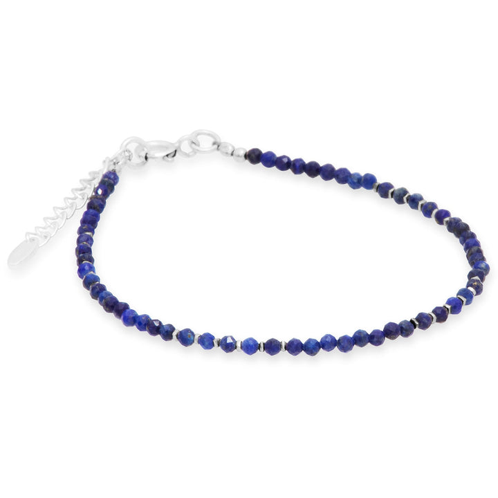 A bracelet with faceted lapis lazuli beads and silver beads, finished with a high polish.