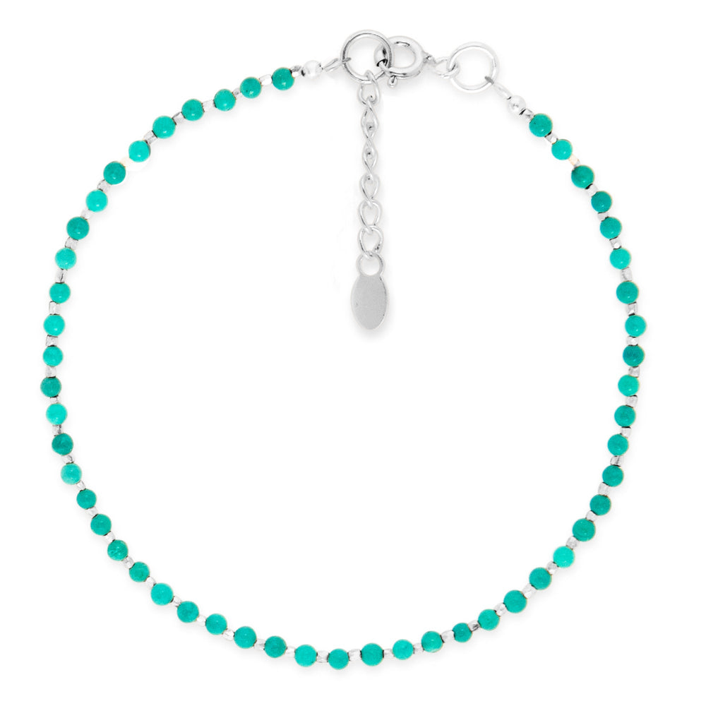 A bracelet with turquoise beads and silver accents, featuring an adjustable clasp on white background