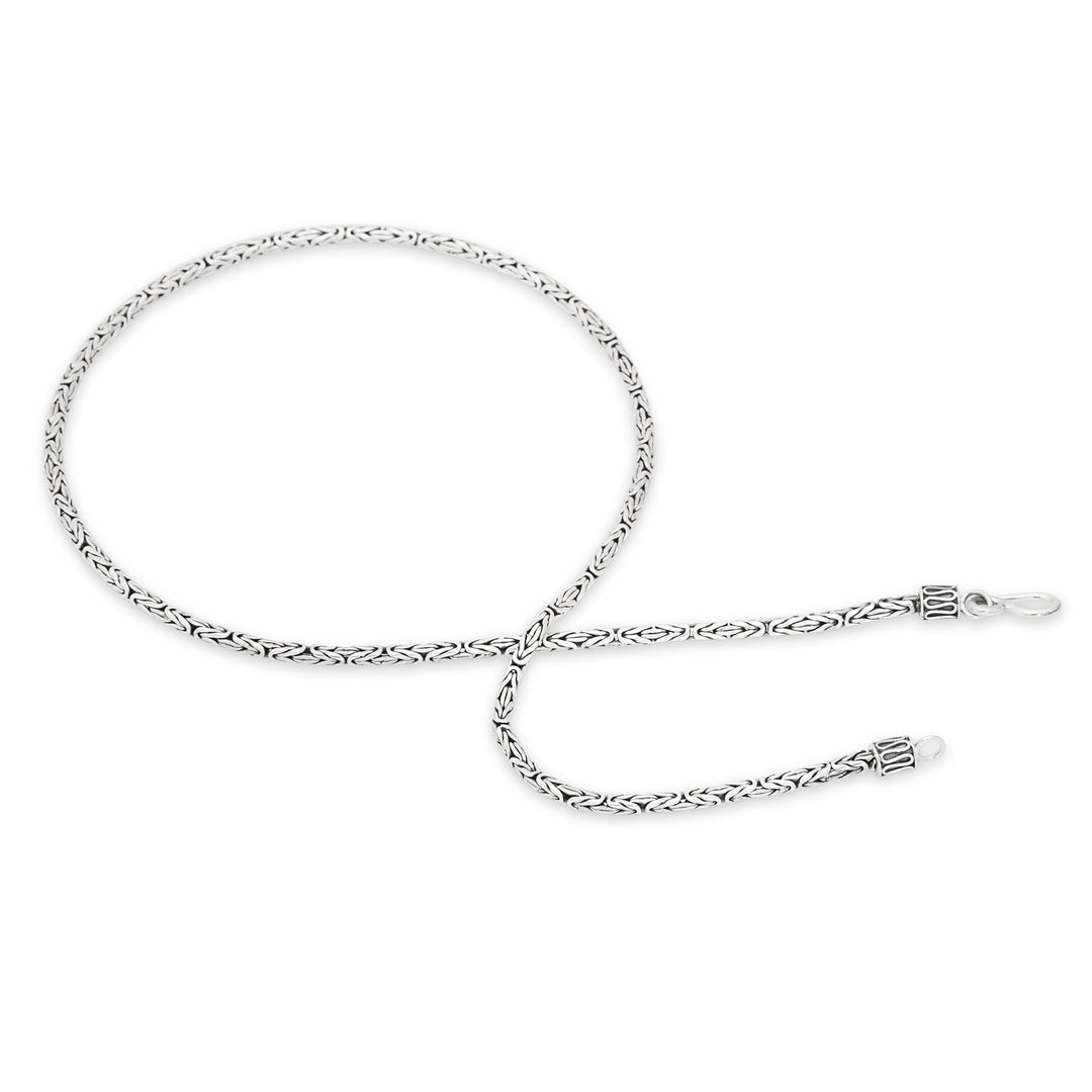 A 925 sterling silver necklace with a Borobudur weave design, featuring a high polish and oxidised finish.