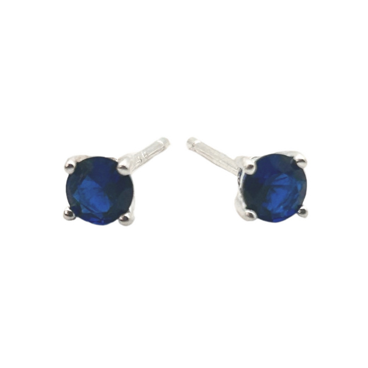 Pair of blue gemstone stud earrings on a white background