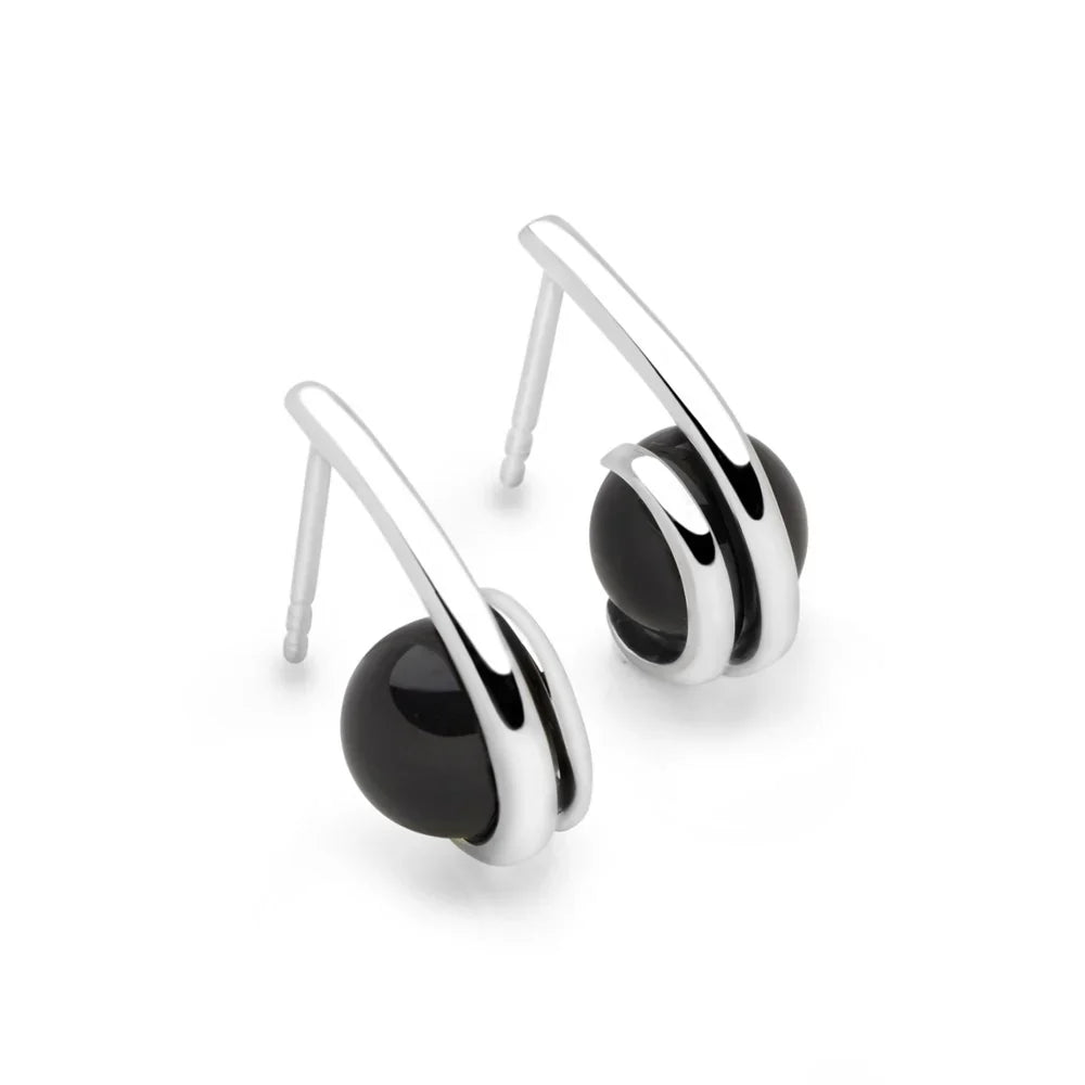 A pair of silver-colored earrings with black onyx stones, displayed against a white background.