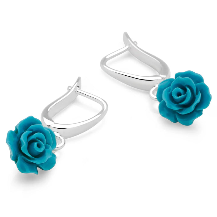 Silver hoop earrings with turquoise rose-shaped charms on a white background