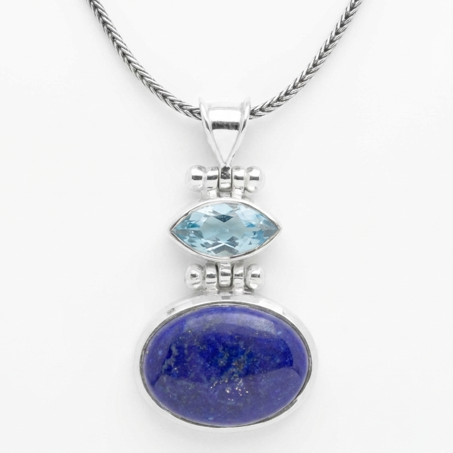 Silver pendant with blue gemstone on a white background