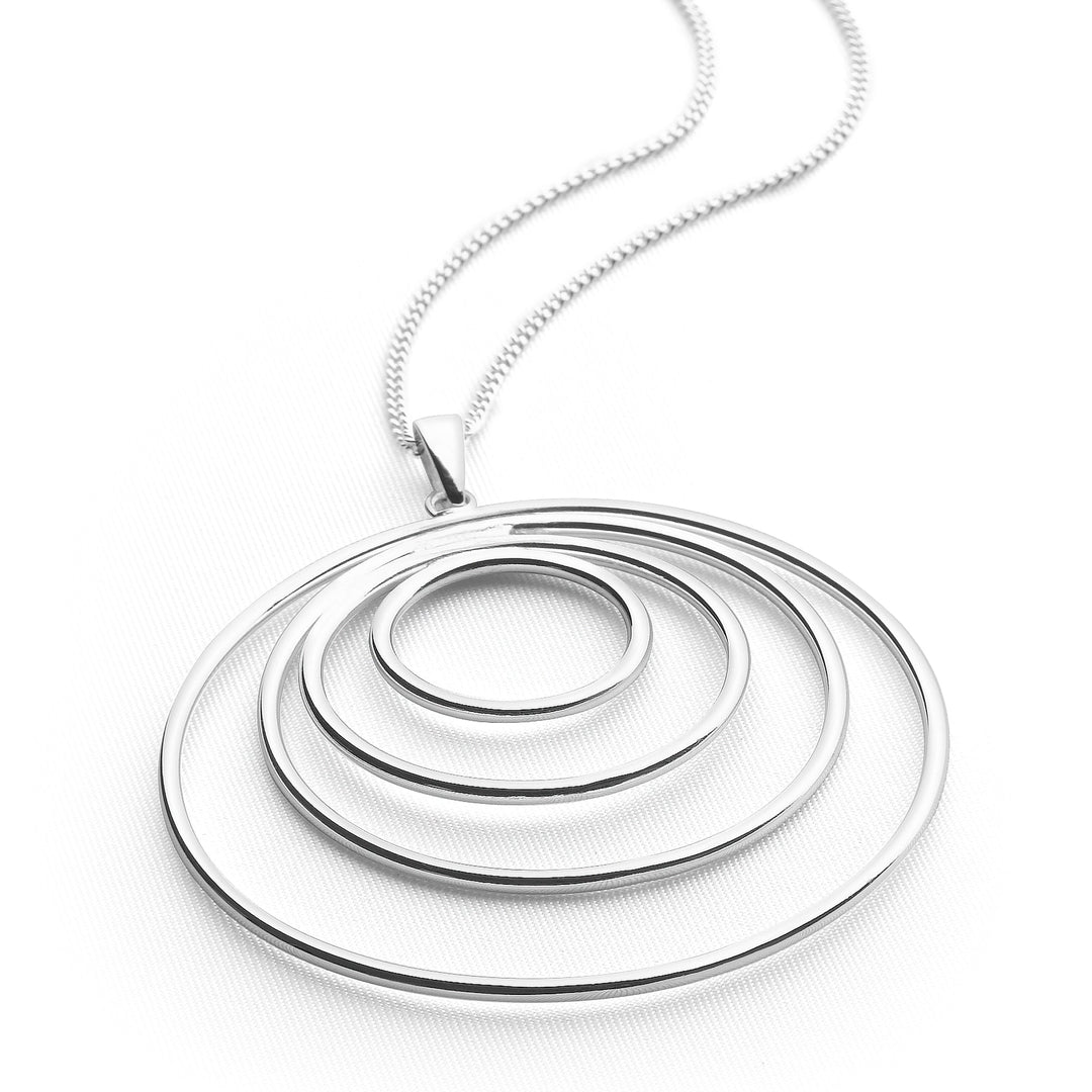 a silver necklace with a series of interlocking circles as the pendant