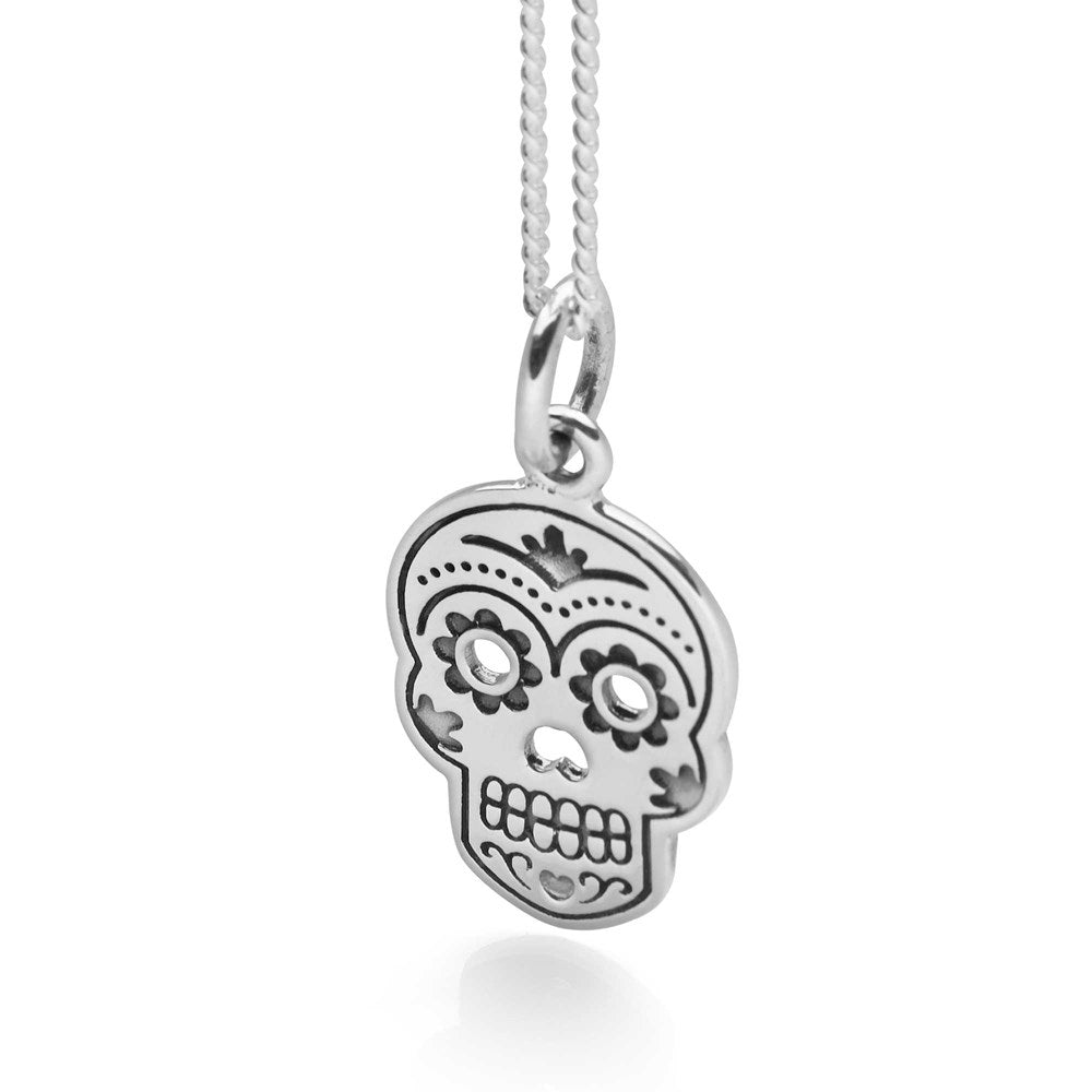 A 925 sterling silver necklace featuring a whimsical sugar skull pendant with floral details, attached to a 40cm curb chain.