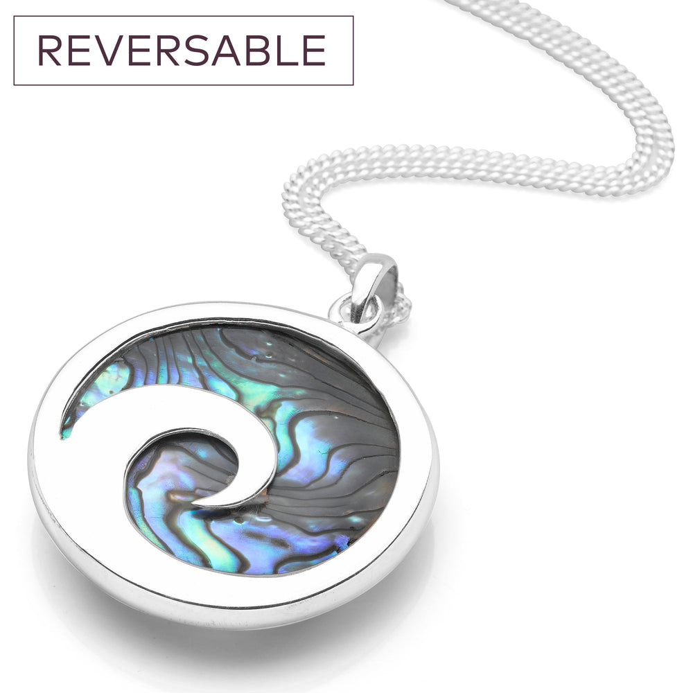 A silver pendant necklace featuring a rolling wave design with a abalone sea shell inlay, on a curb chain.