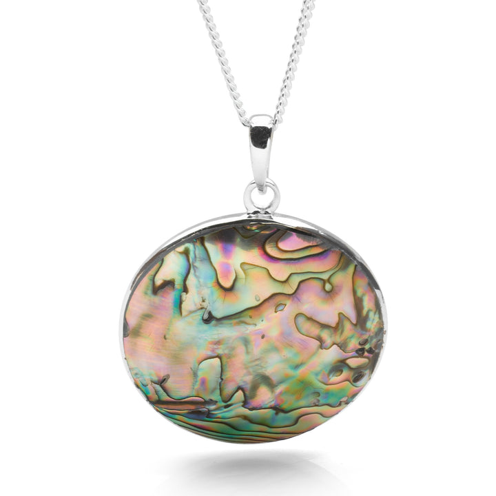 A silver pendant necklace featuring a rolling wave design with a abalone sea shell inlay, on a curb chain.