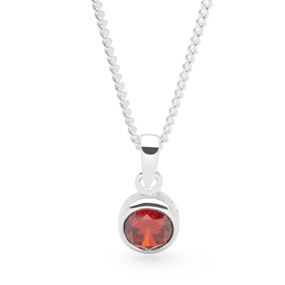 A sterling silver pendant with a dark garnet cubic zirconia on a curb chain.