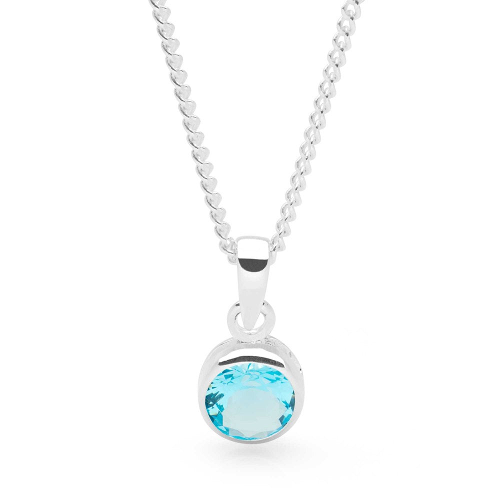 A sterling silver pendant with a blue cubic zirconia set in a round, bezel-style setting, attached to a 40cm curb chain.