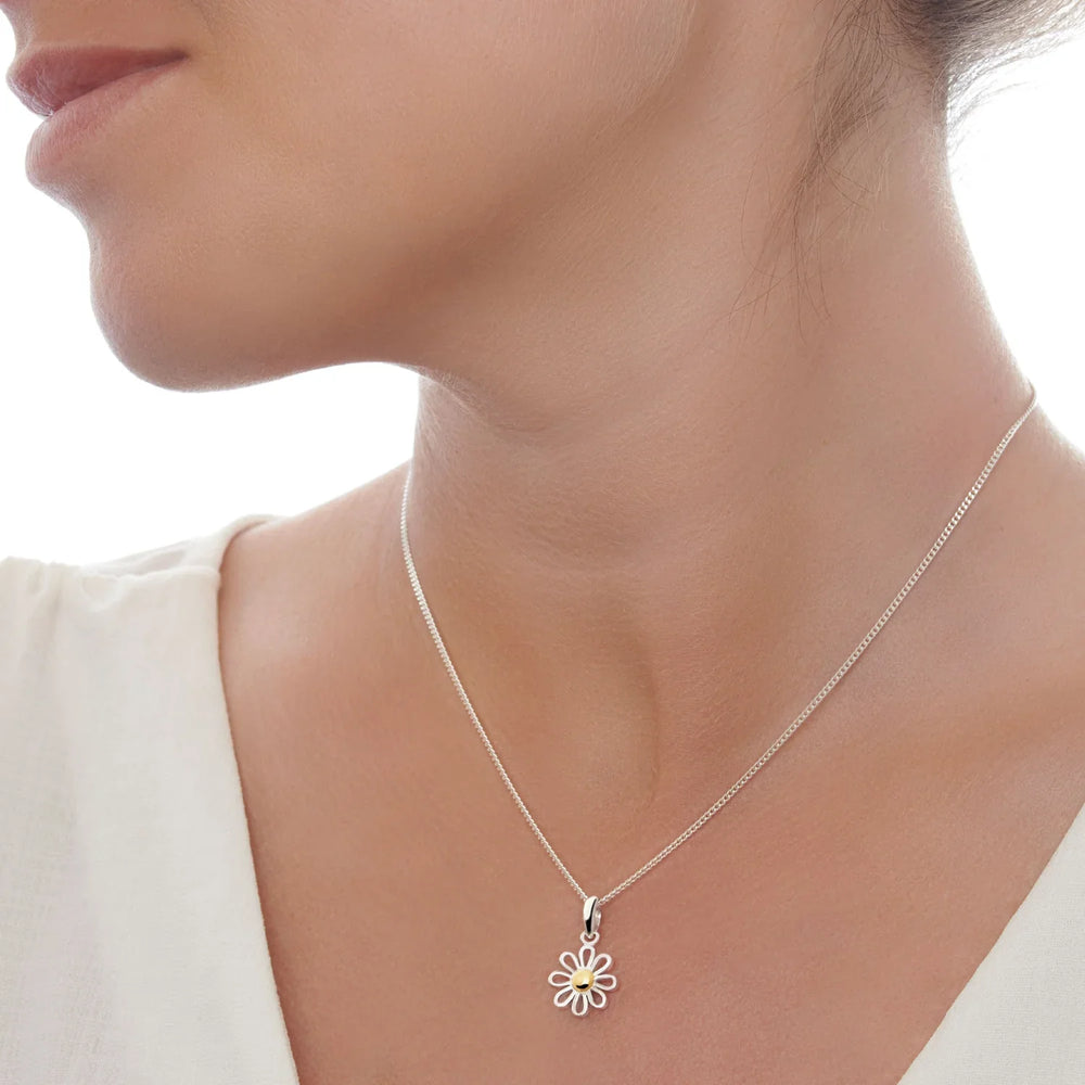 A silver pendant with bright silver petals and a golden center, attached to a 40cm curb chain.