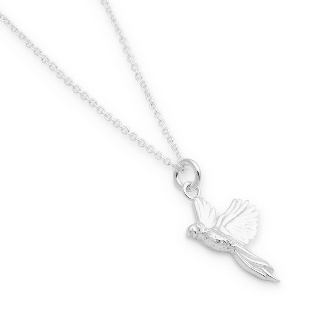 A silver necklace with a detailed parrot pendant in flight position, attached to a simple loop at the top.