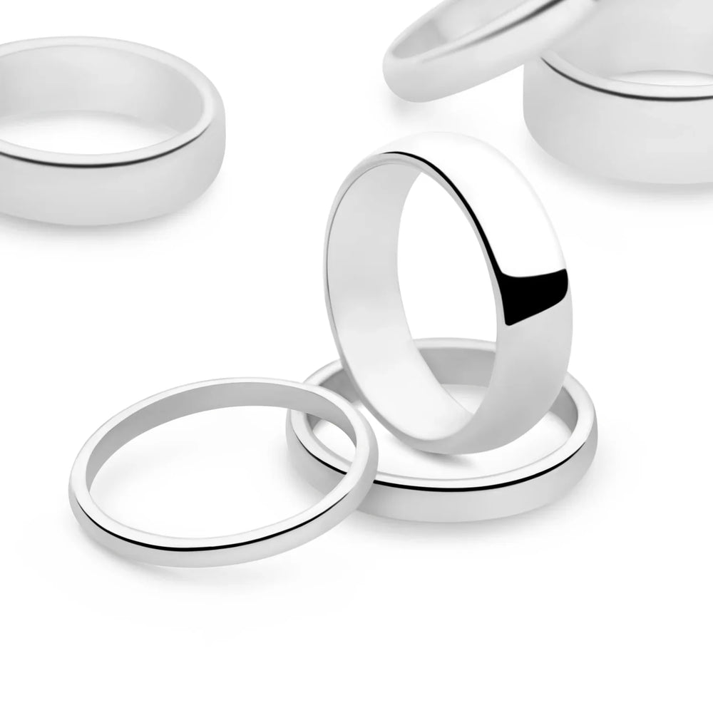 A D-shaped silver band ring with a smooth curved edge and a high polish finish. Sterling silver. 