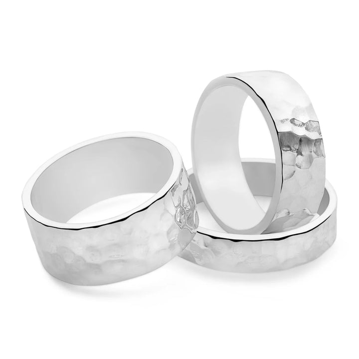 A flat, hammered finish silver band ring with a width of 5mm. White background. 
