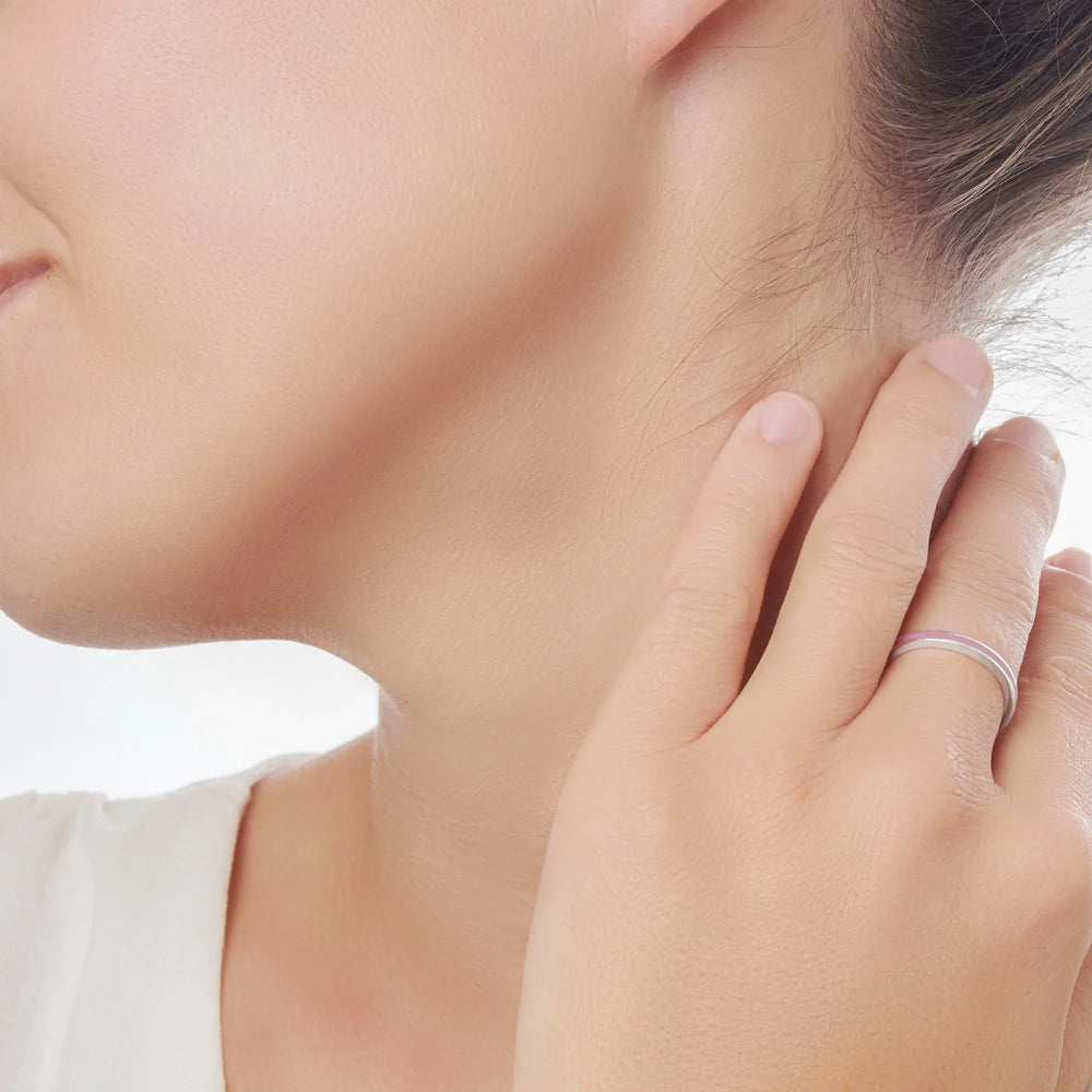 Close-up of a person wearing a silver ring on a model background