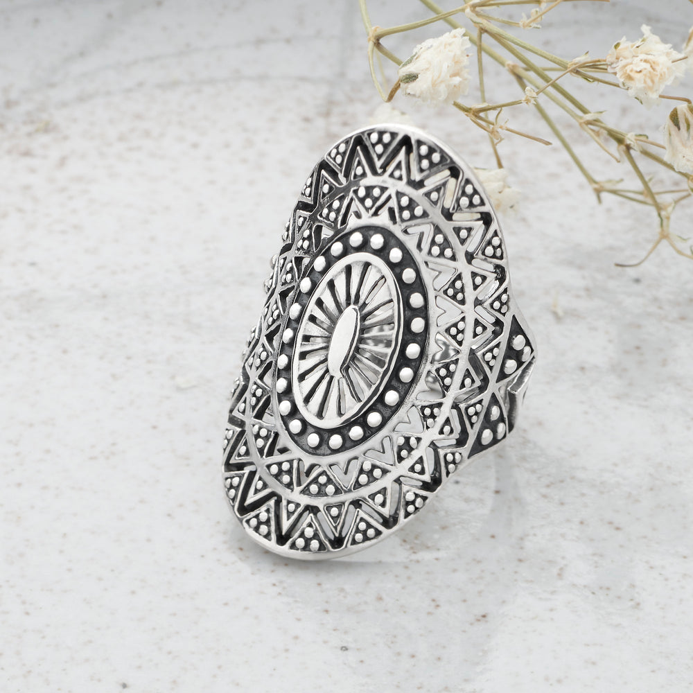 A sterling silver ring with a detailed Sun Burst Mandala design, featuring a central circular pattern surrounded by intricate geometric shapes.