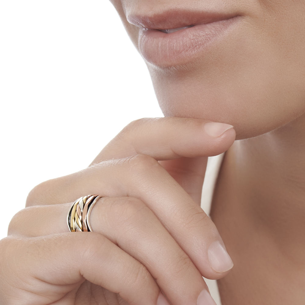 A wavy 925 sterling silver band, wrapped with bands of twisted silver, brass and copper which move freely spin ring