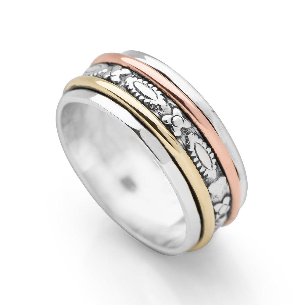 A sterling silver ring with solid brass and copper bands that spin around the central part of the ring, featuring a high polish and oxidised finish.