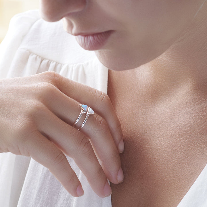 Model wearing 925 sterling silver double band with 2 synthetic blue & white opal triangles ring (R20531)