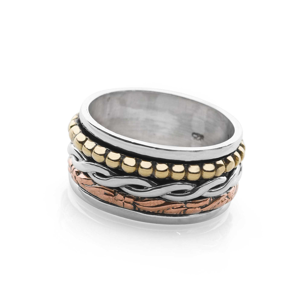A sterling silver ring with solid brass and copper bands, featuring a high polish and oxidised finish, with the ability to spin on white background. 