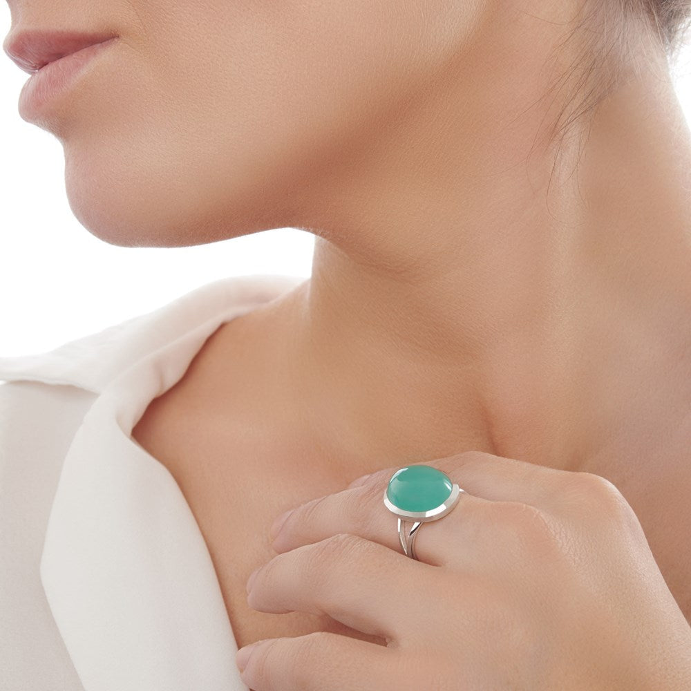 An oval-shaped green stone set in a high polished sterling silver ring female model. 