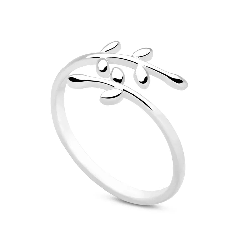 A silver ring with an open design featuring a silver fern motif on a white background.