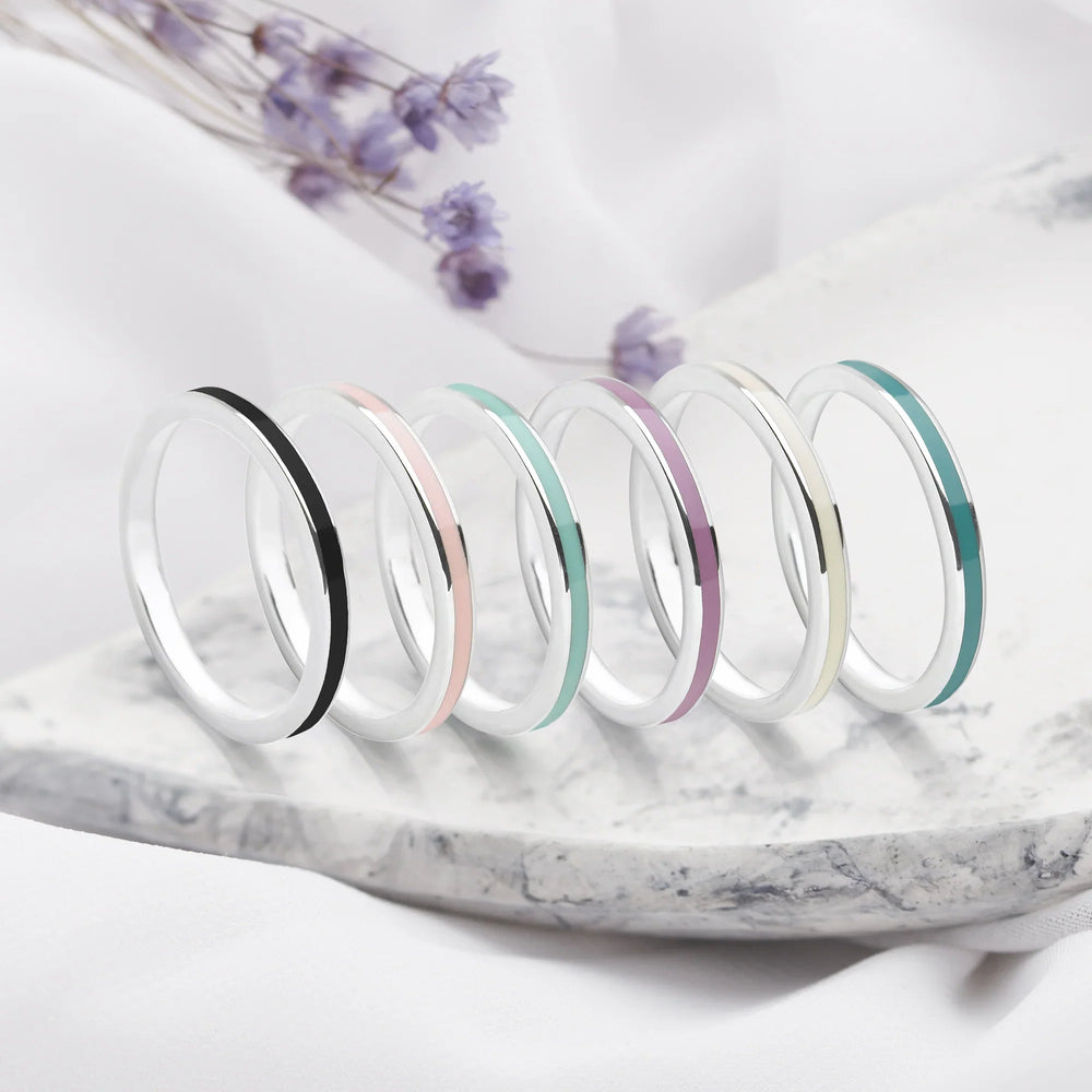 A set of silver rings with different coloured enamel channel inlays.